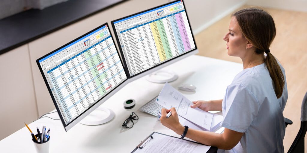 Medical Bill Codes And Spreadsheet Data. Business Analyst Woman